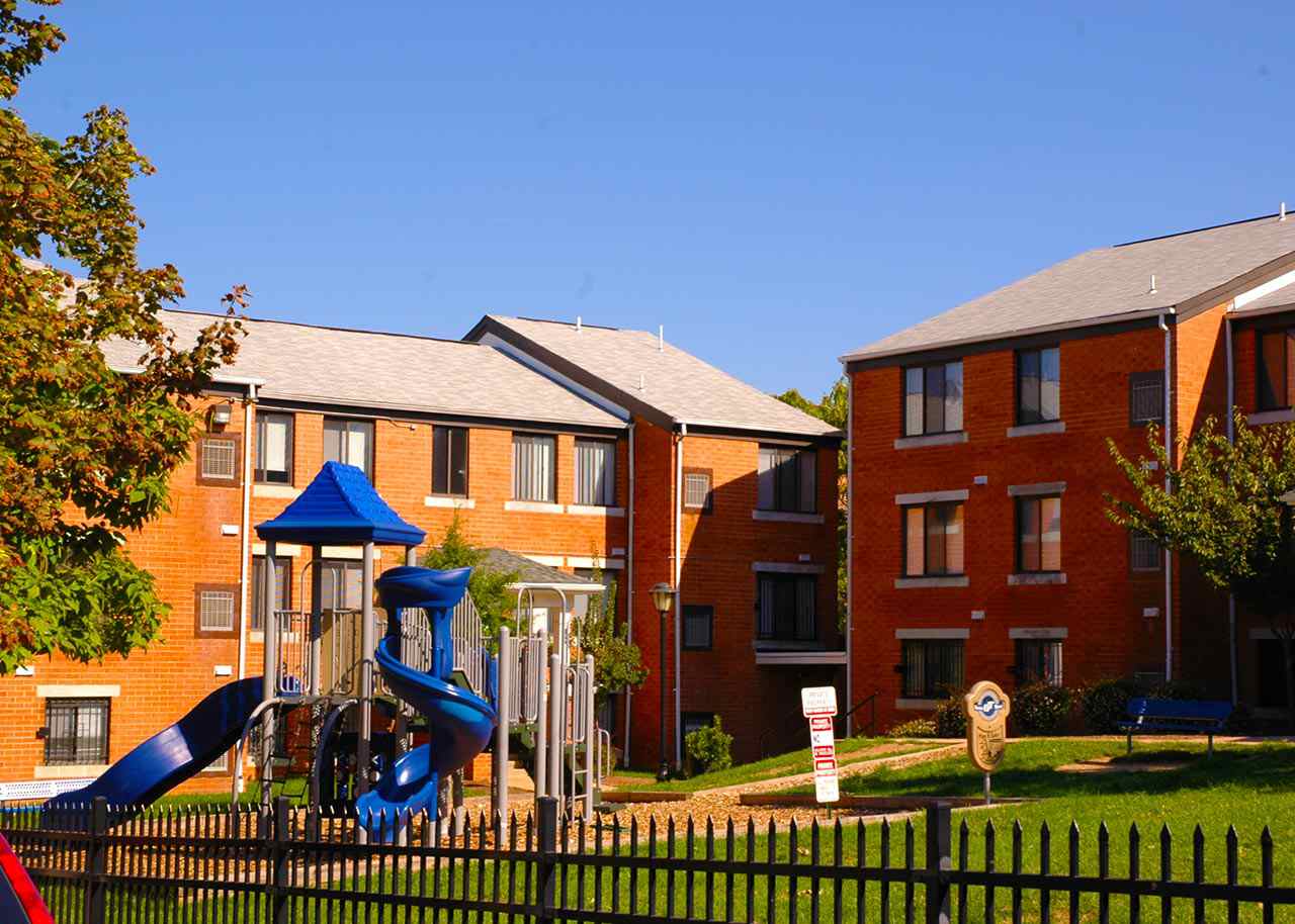 a playground in front of an apartment complex