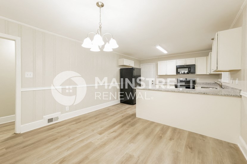 a studio apartment with a kitchen and a living room