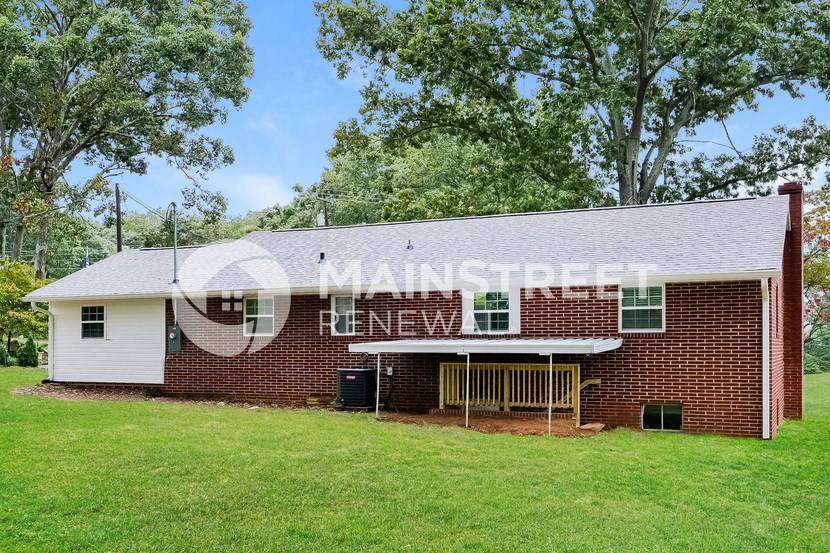 a large brick house with a lawn in front of it