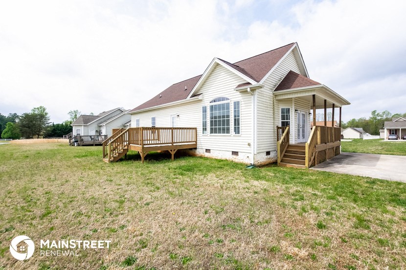 a white house with a porch and a deck