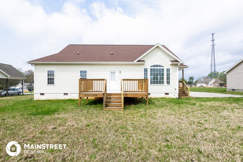 a white house with a porch and a deck