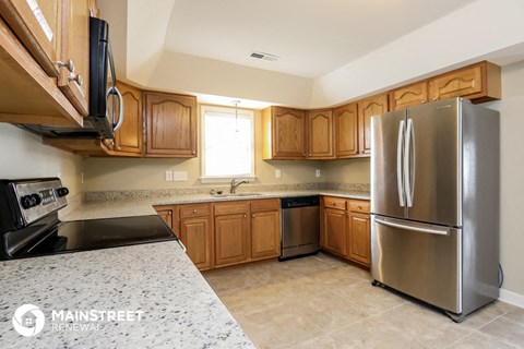 a kitchen with stainless steel appliances and wooden cabinets