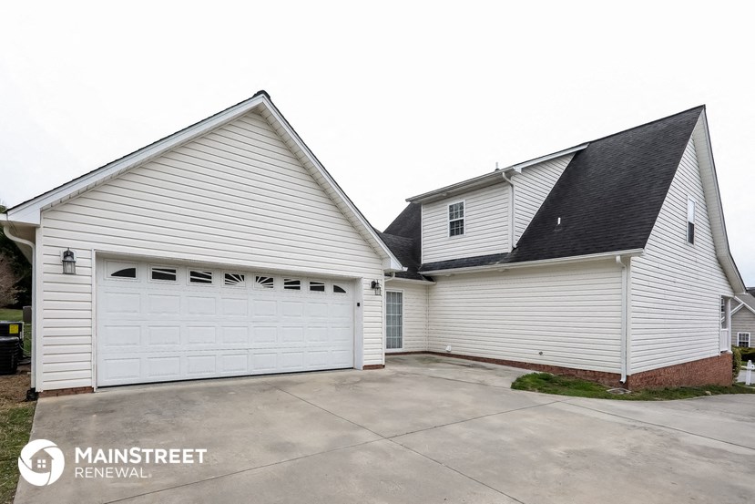 the view of the garage and the house from the driveway