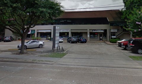a parking lot with cars parked in front of a building