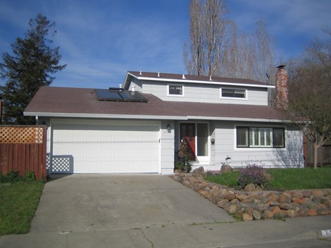 A house with a brown roof and a white garage door.