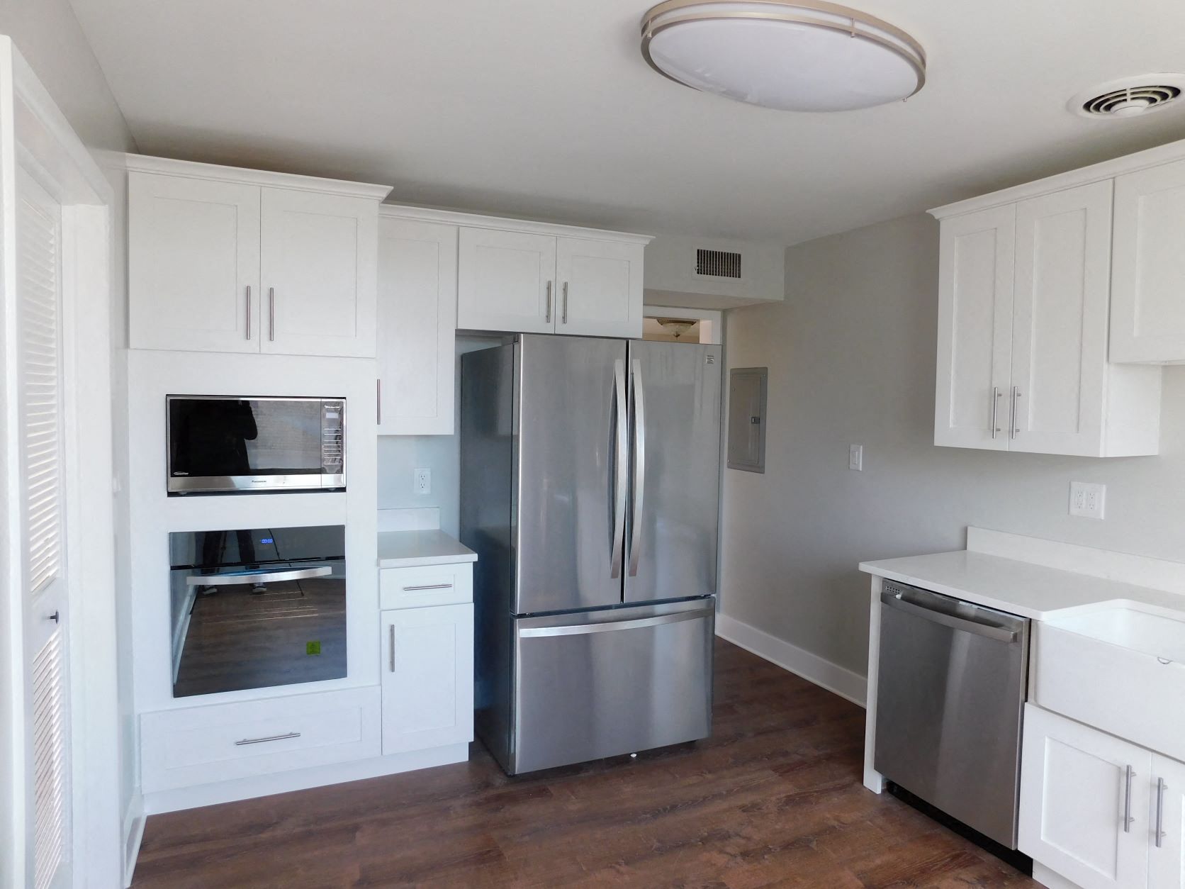 a kitchen with white cabinets and stainless steel appliances