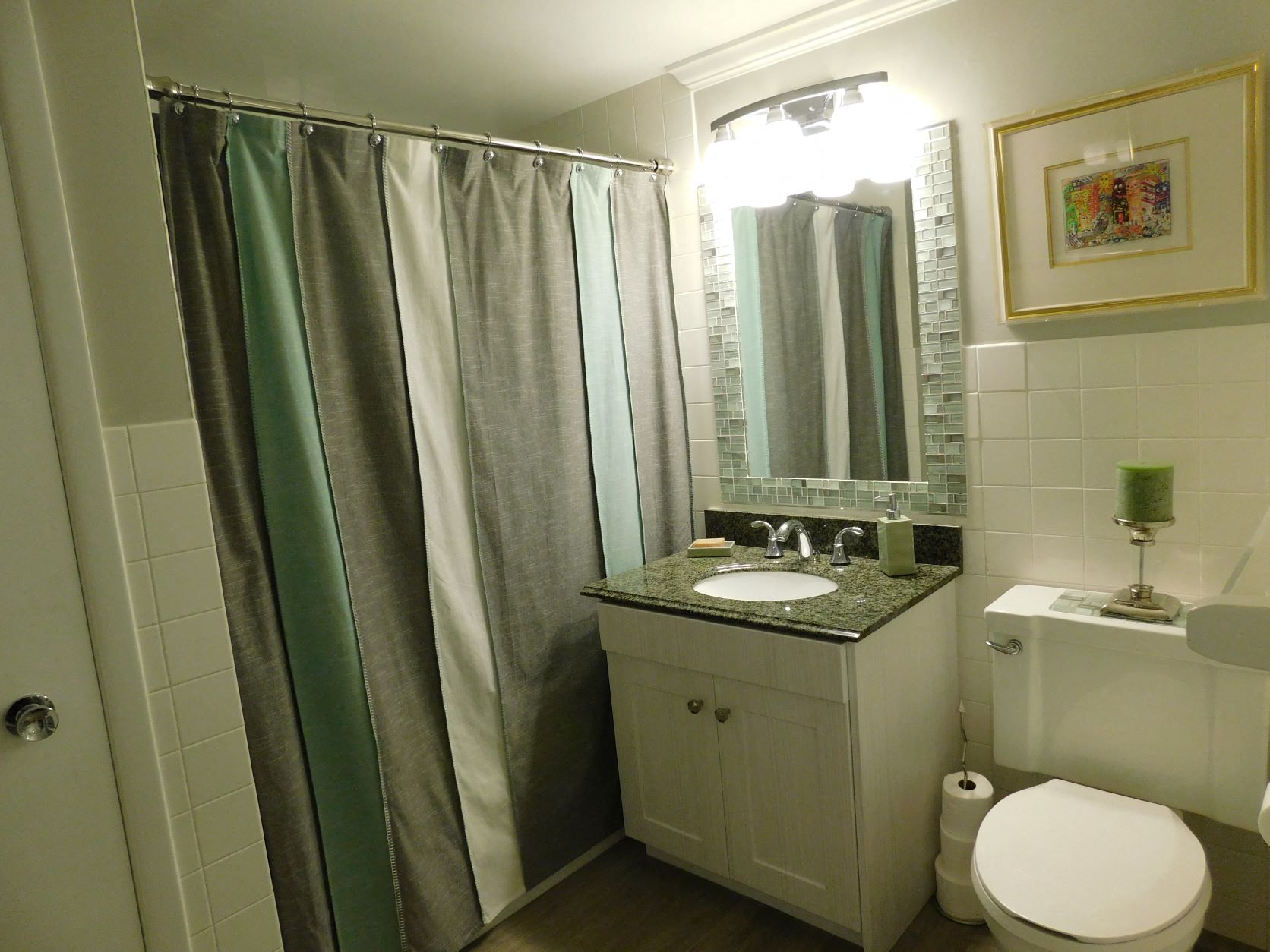 a small bathroom with a sink toilet and shower