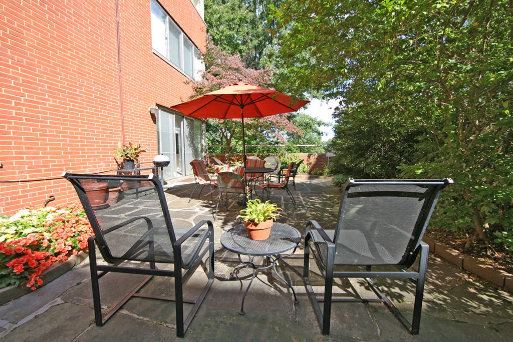 a patio with a table and chairs and an umbrella