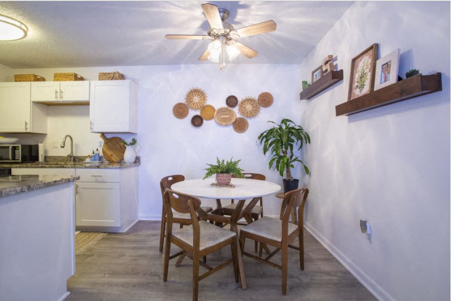 a kitchen and dining room with a table and chairs