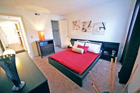 a bedroom with a bed and a dresser and a window