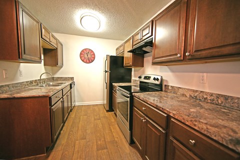 a kitchen with stainless steel appliances and marble counter tops
