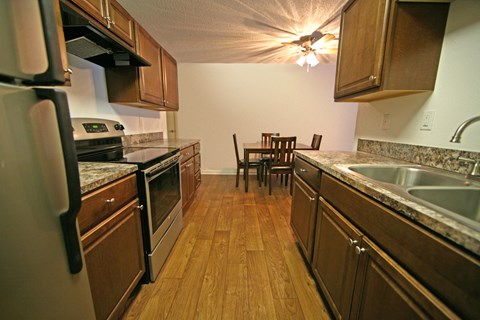 a kitchen with wooden cabinets and stainless steel appliances