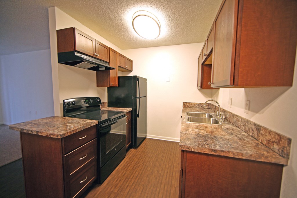 a kitchen with black appliances and granite counter tops