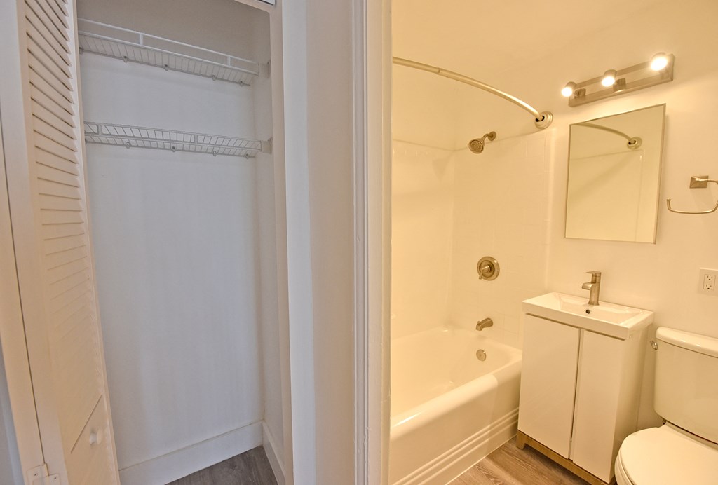 a bathroom with a shower and a toilet and a sink