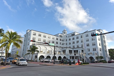 a large white building on the corner of a city street