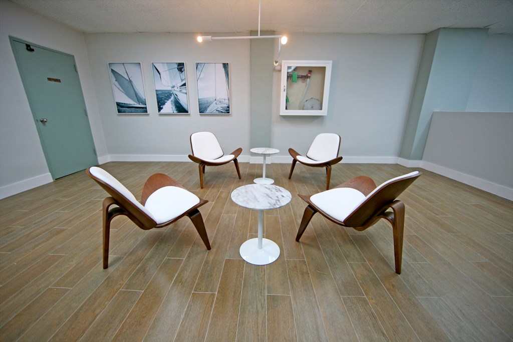 a circle of chairs and a table in a room
