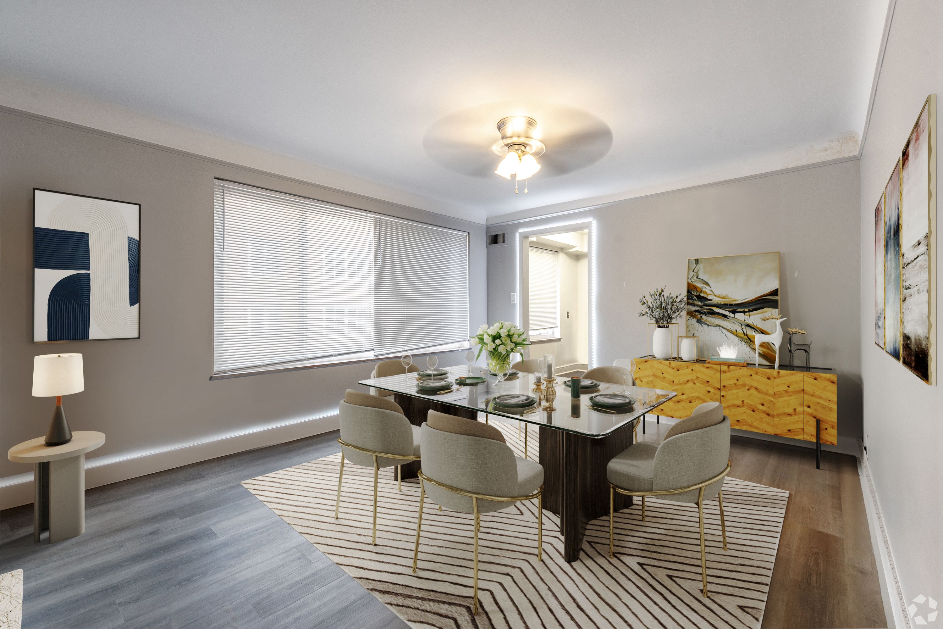 A dining room with a table set for six.