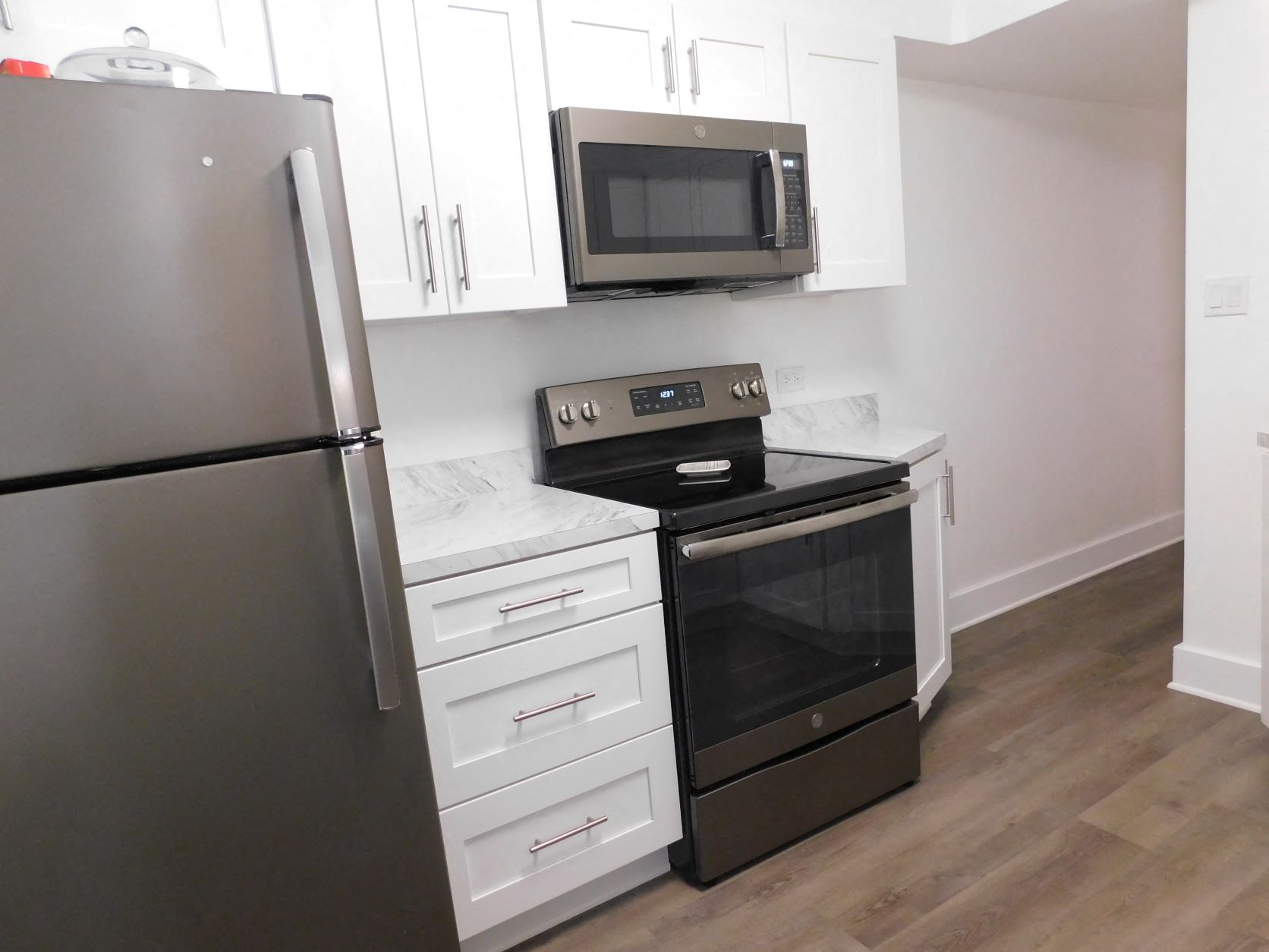 a kitchen with stainless steel appliances and white cabinets