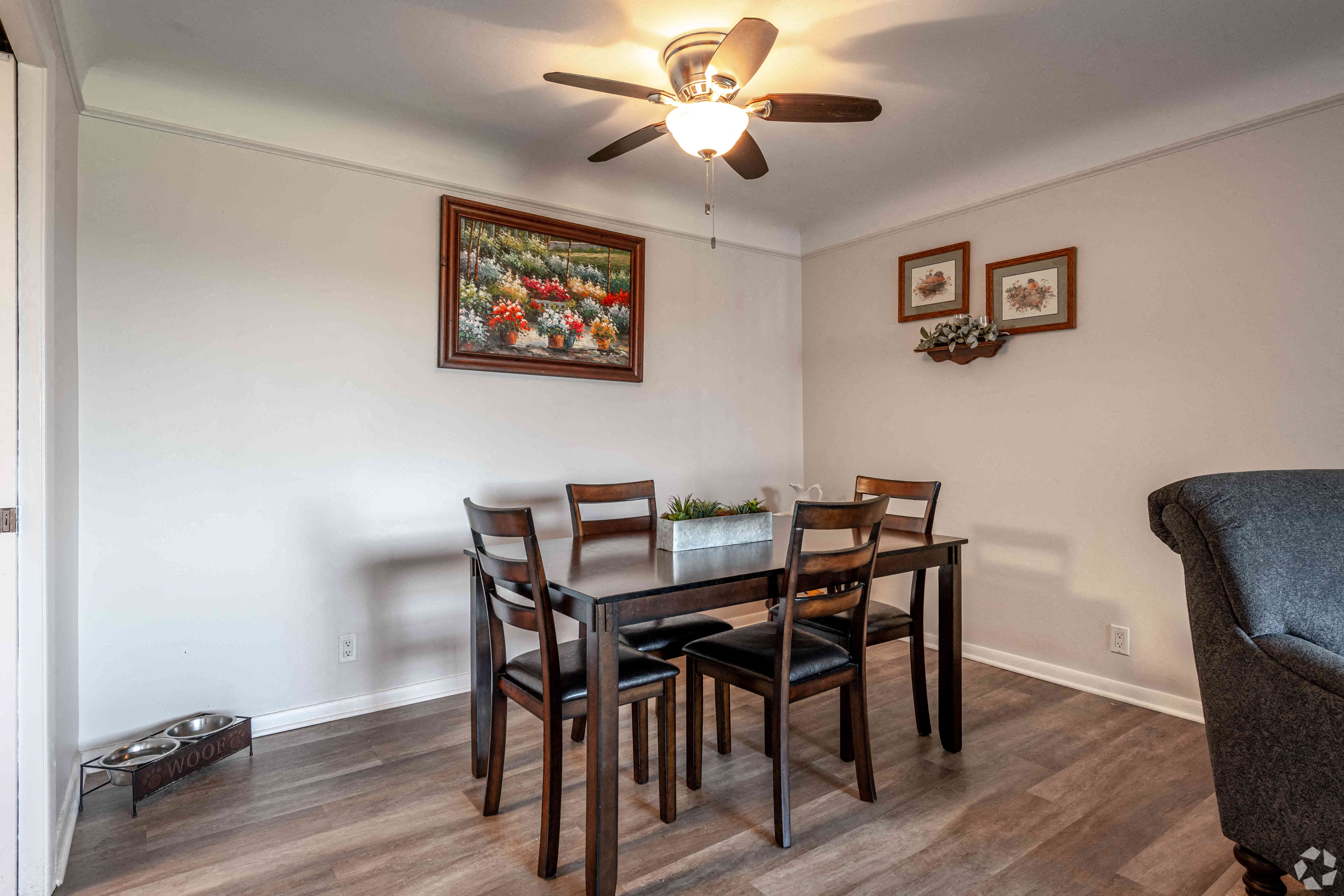 a dining room table with chairs and a ceiling fan