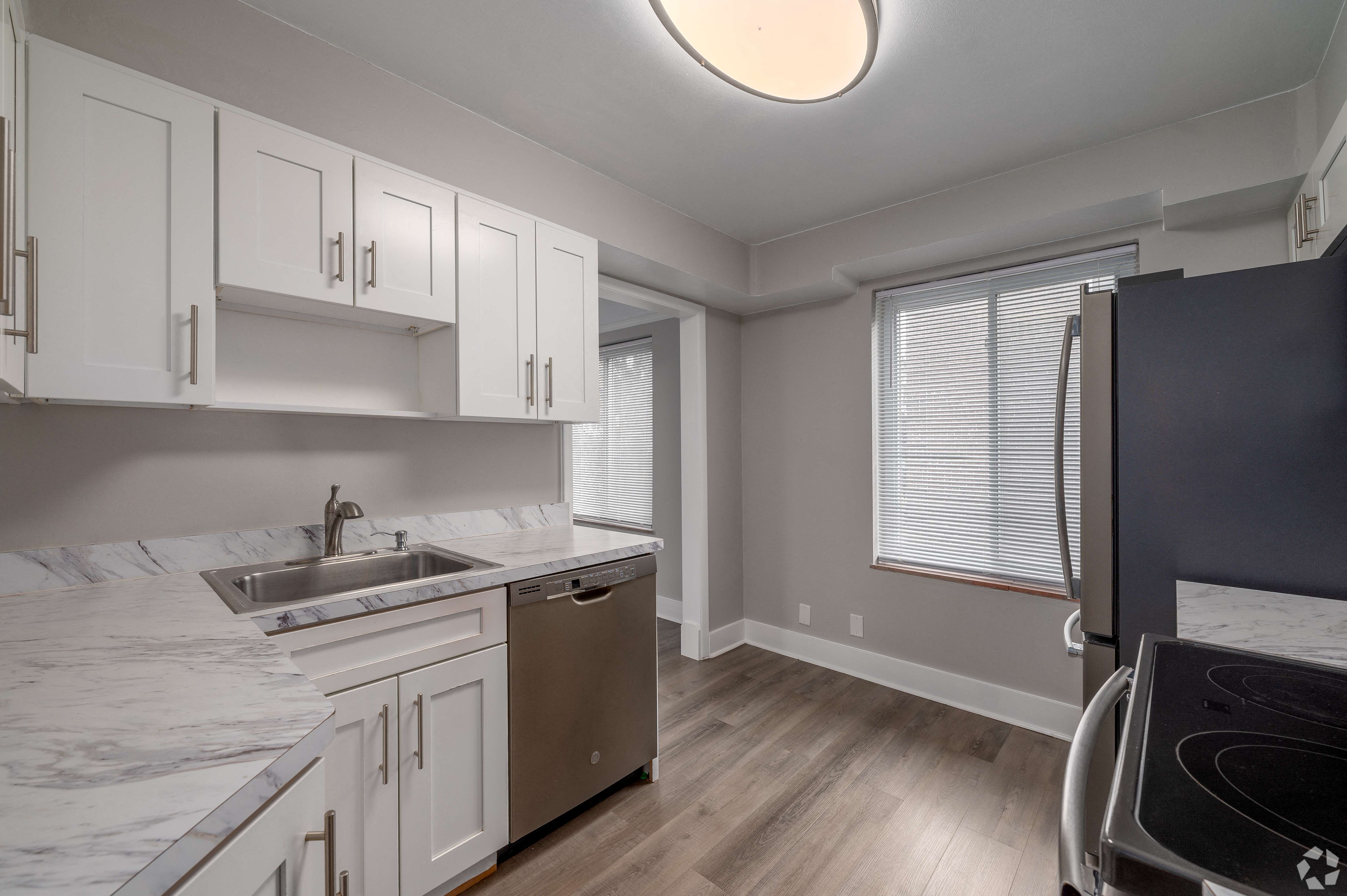 the kitchen in a new home with white cabinets and stainless steel appliances