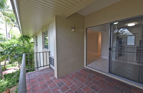 a view of the front porch of a house with a sliding glass door