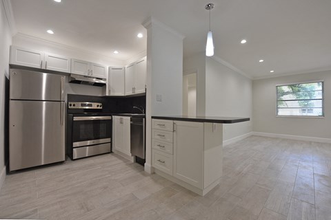 a kitchen with stainless steel appliances and white cabinets