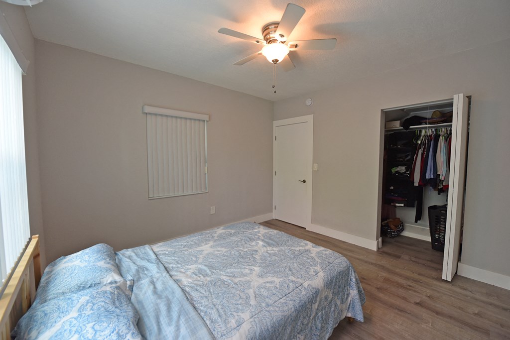 a bedroom with a large bed and a ceiling fan