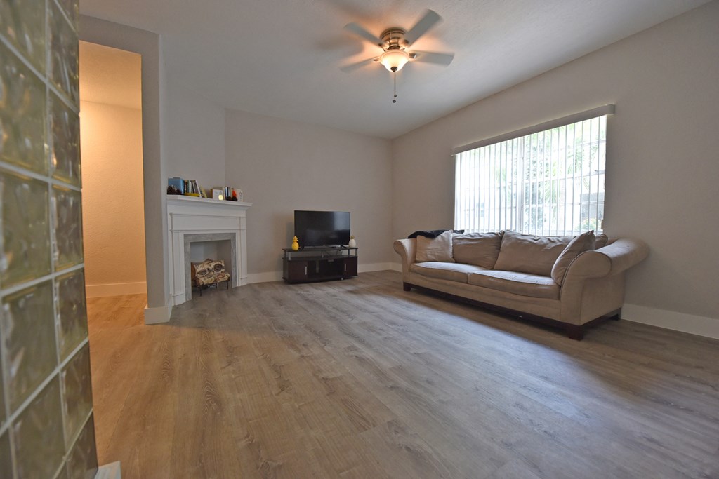 an empty living room with a couch and a tv