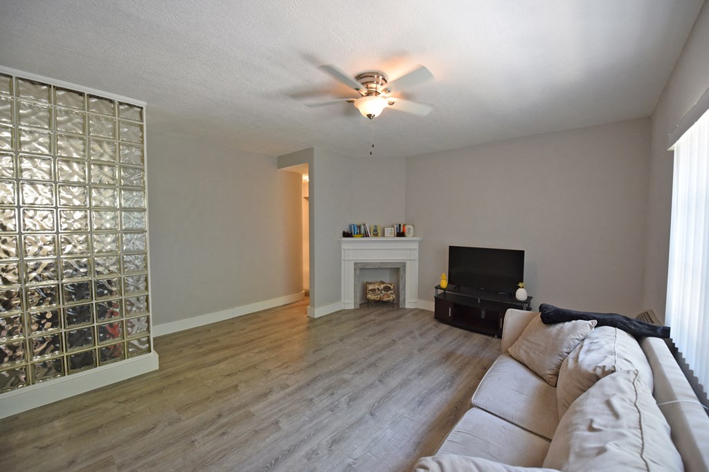 a living room with a couch and a ceiling fan