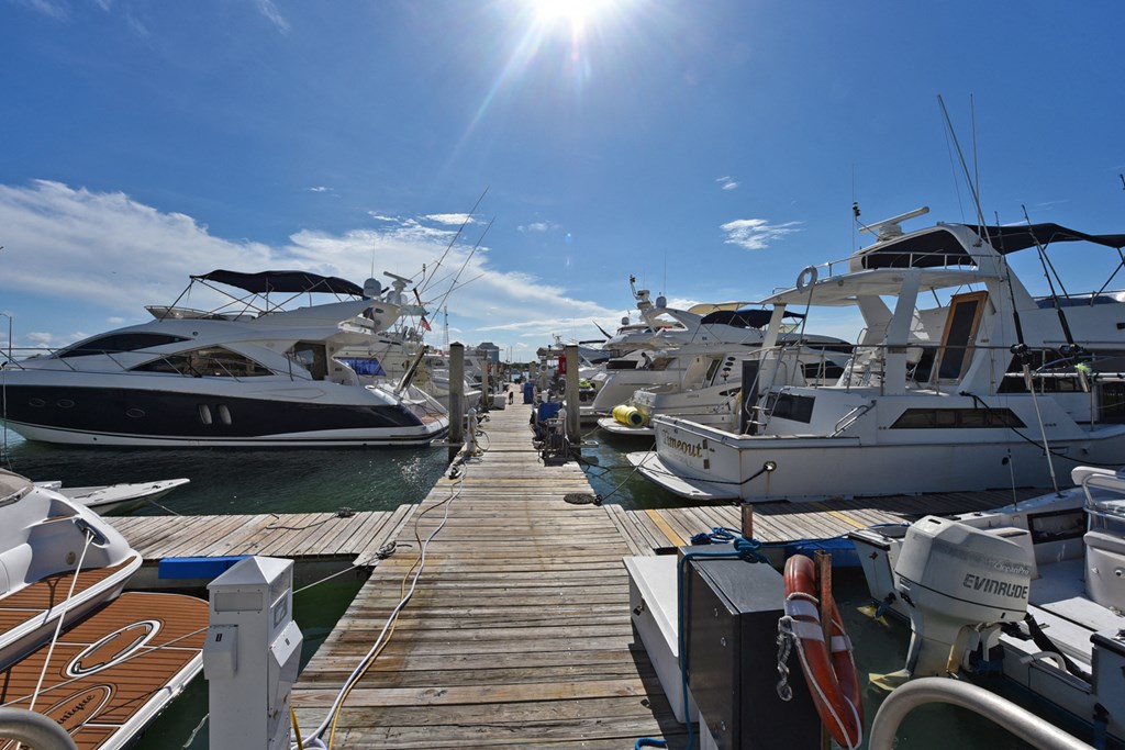 a row of boats docked at a dock in a marina