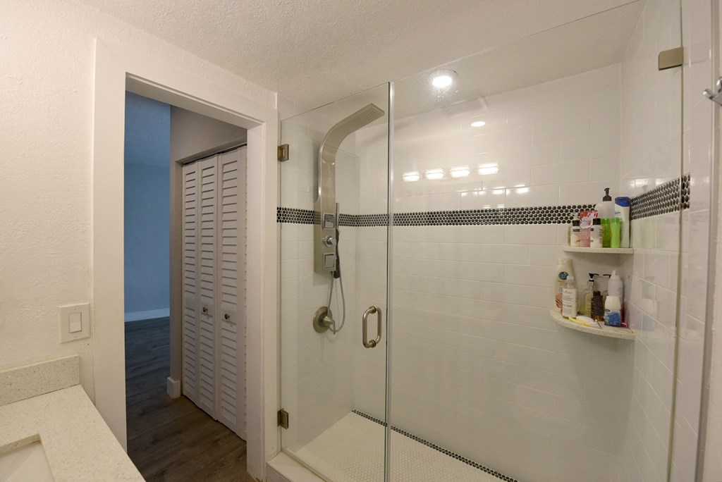 a shower with a glass door in a bathroom
