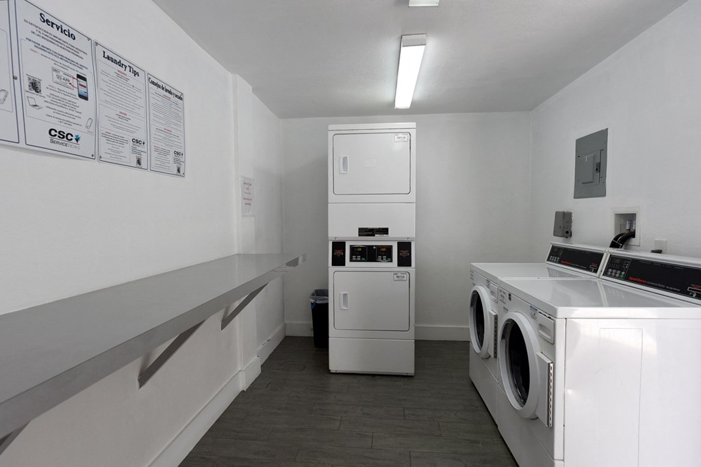a laundry room with a washer and dryer and a washing machine