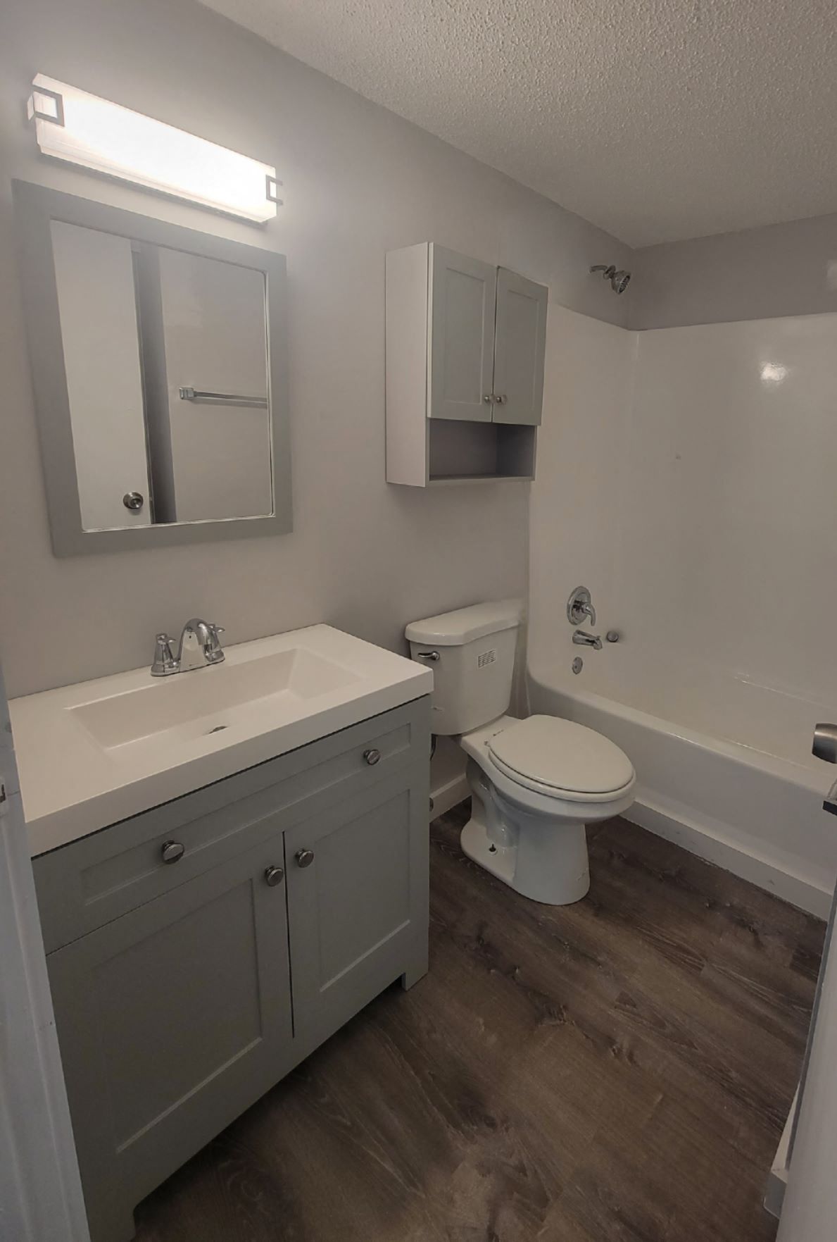 a bathroom with a sink toilet and a mirror