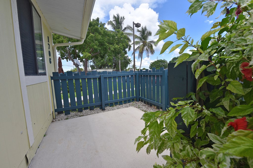 a patio with a blue fence on top of a house