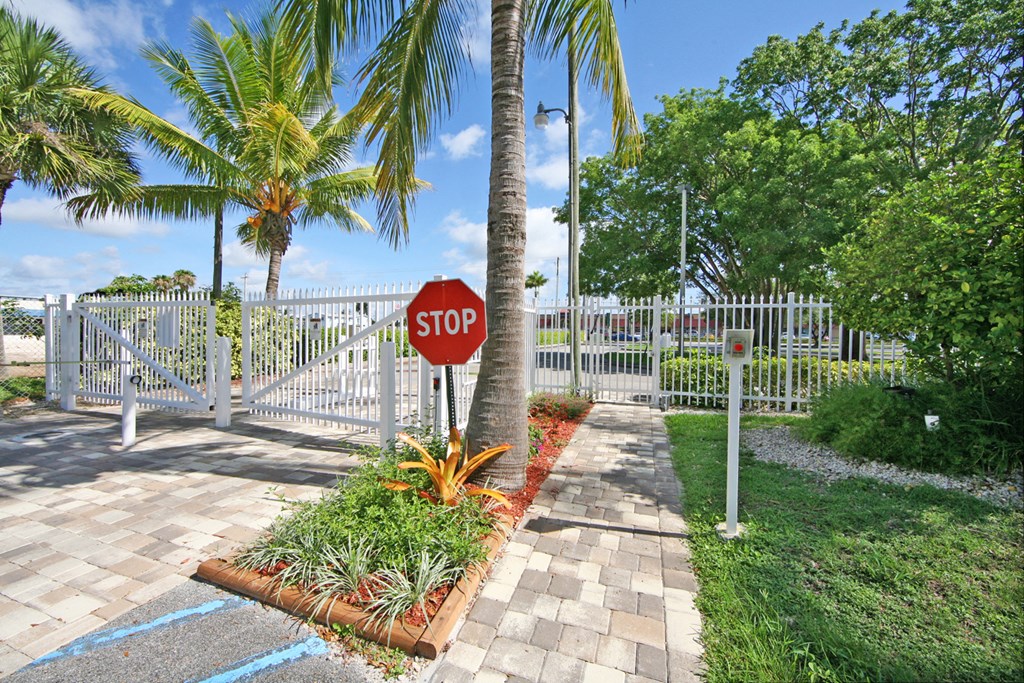 a stop sign in front of a white fence