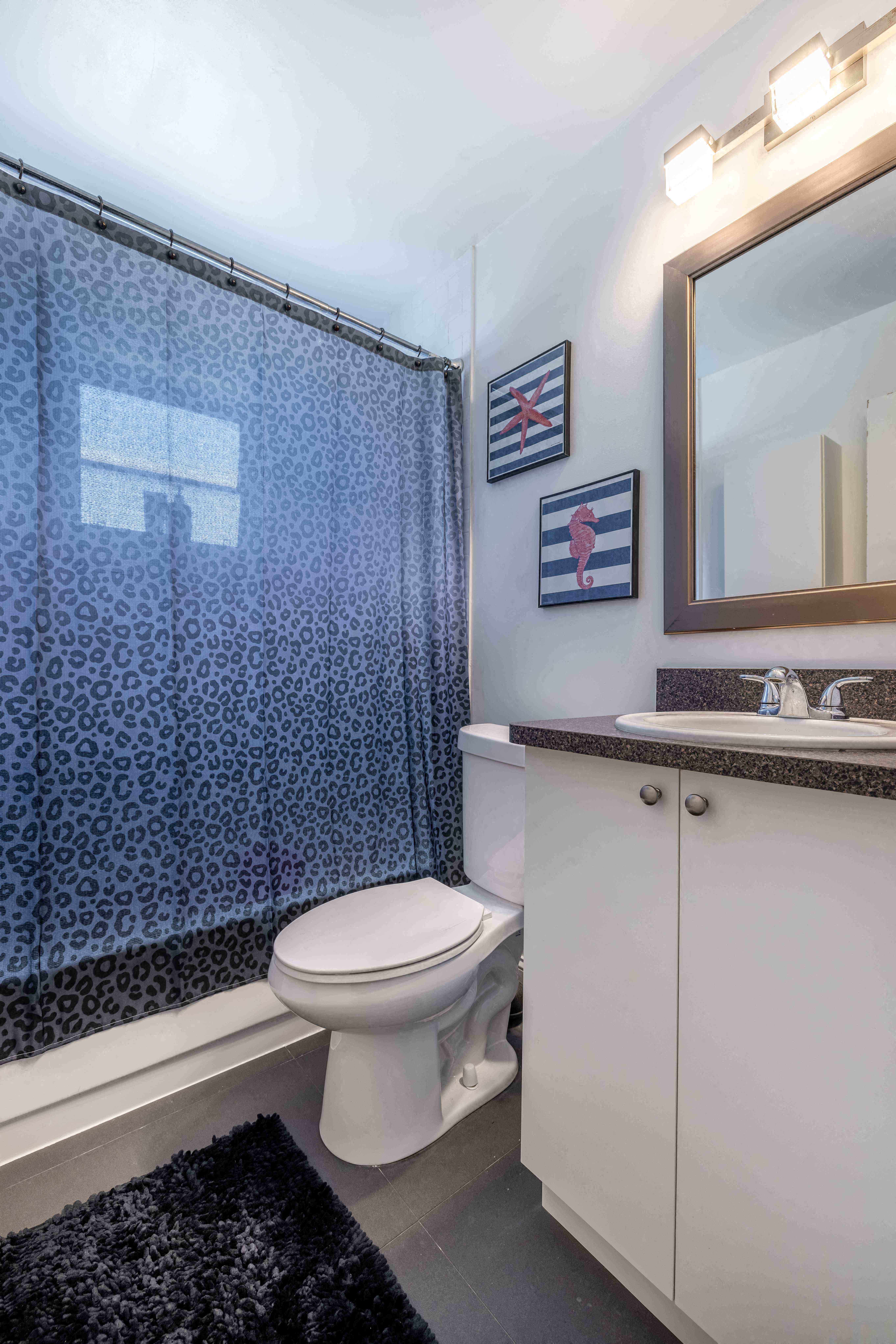 a bathroom with a shower and a toilet and a sink
