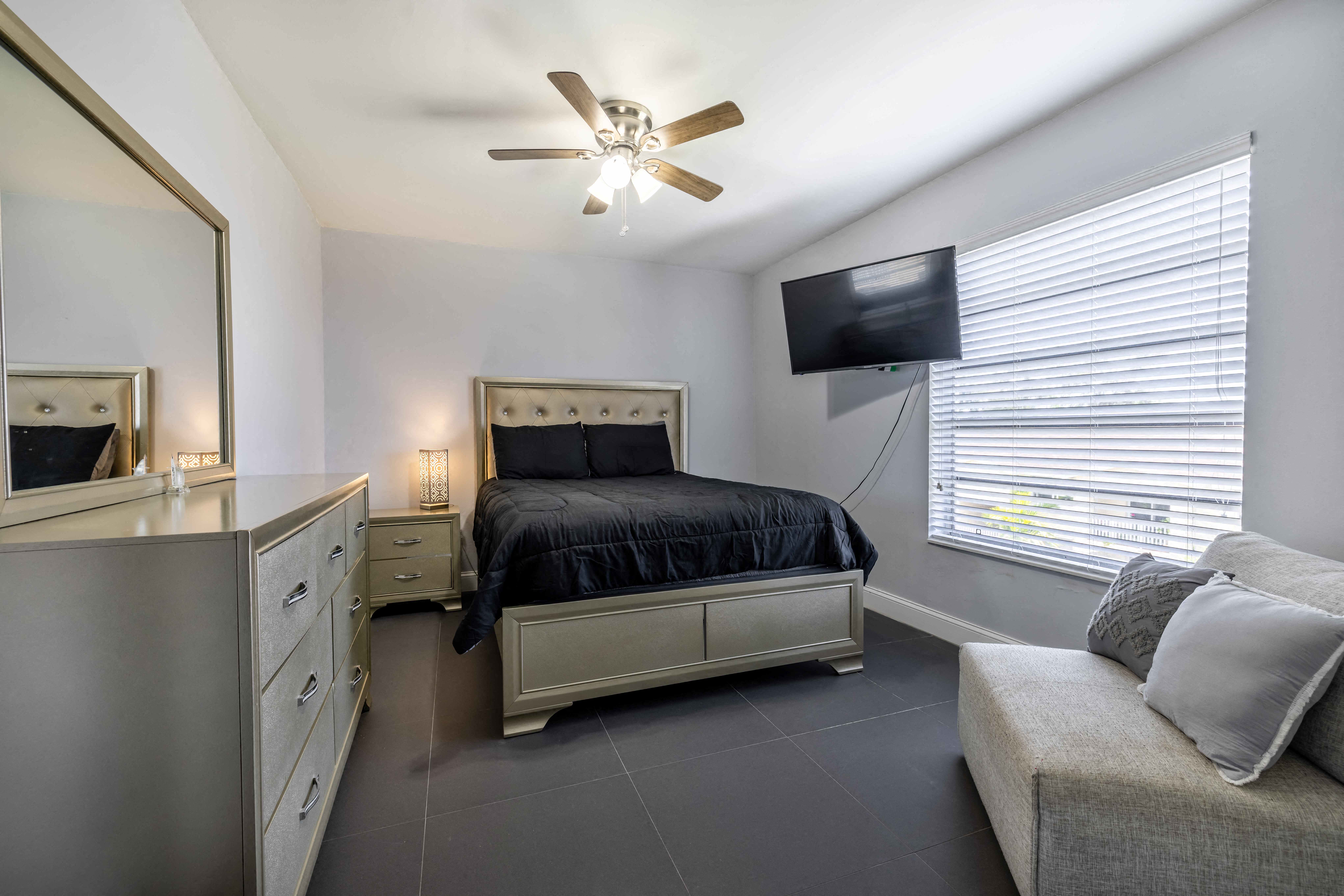 a bedroom with a bed and a ceiling fan