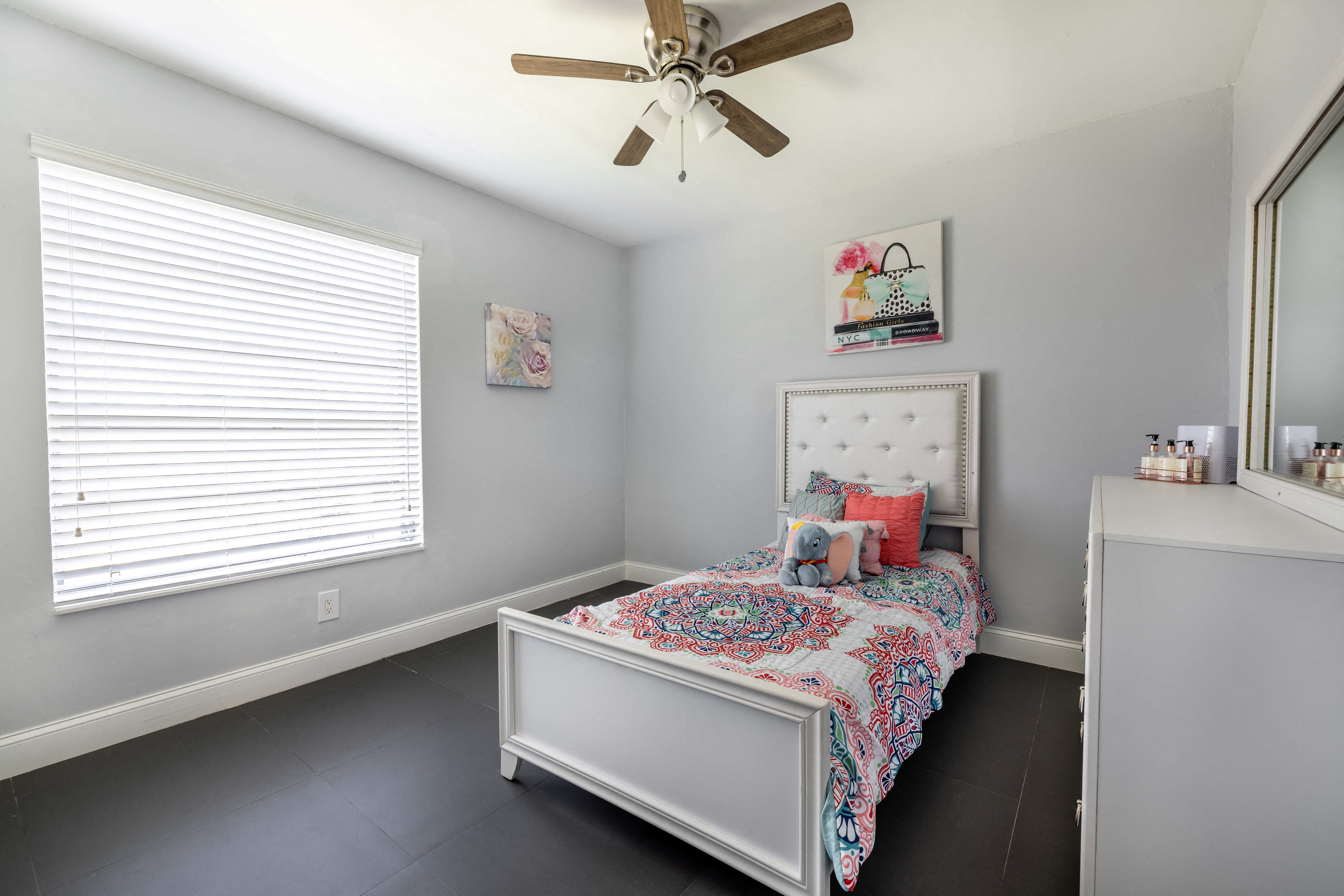 a bedroom with a bed and a ceiling fan