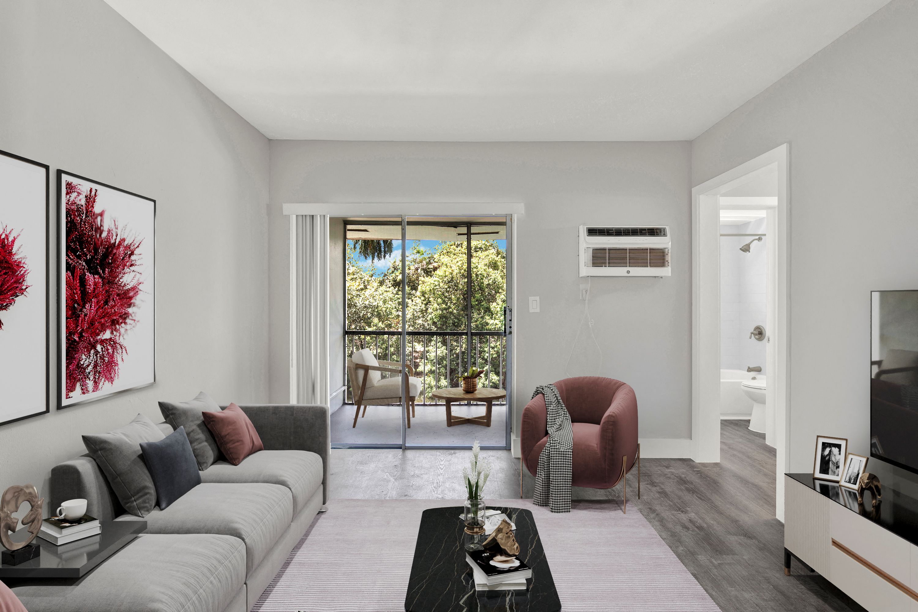 A living room with a grey couch, a red chair, and a television.