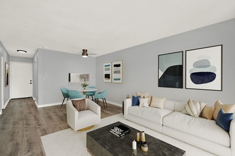 A living room with a white couch and a coffee table.