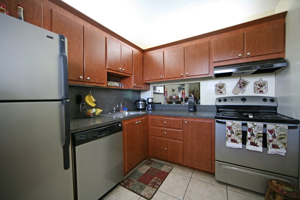a kitchen with stainless steel appliances and wooden cabinets