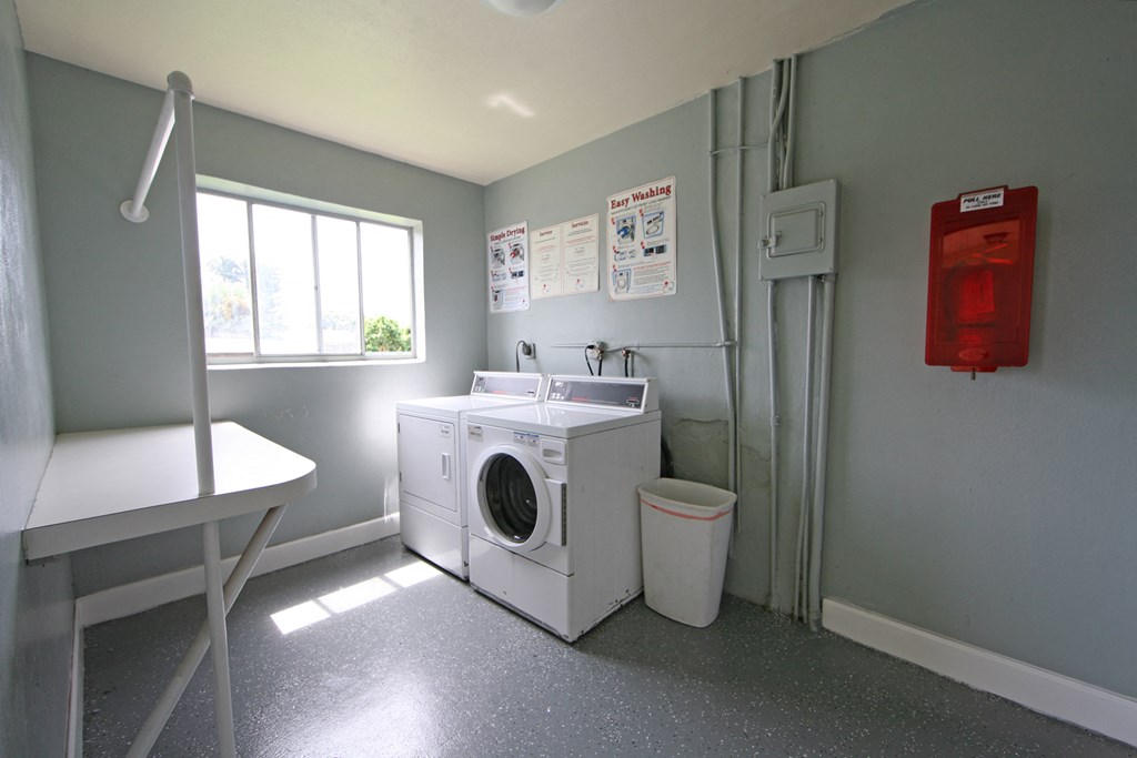a laundry room with a washing machine and a sink