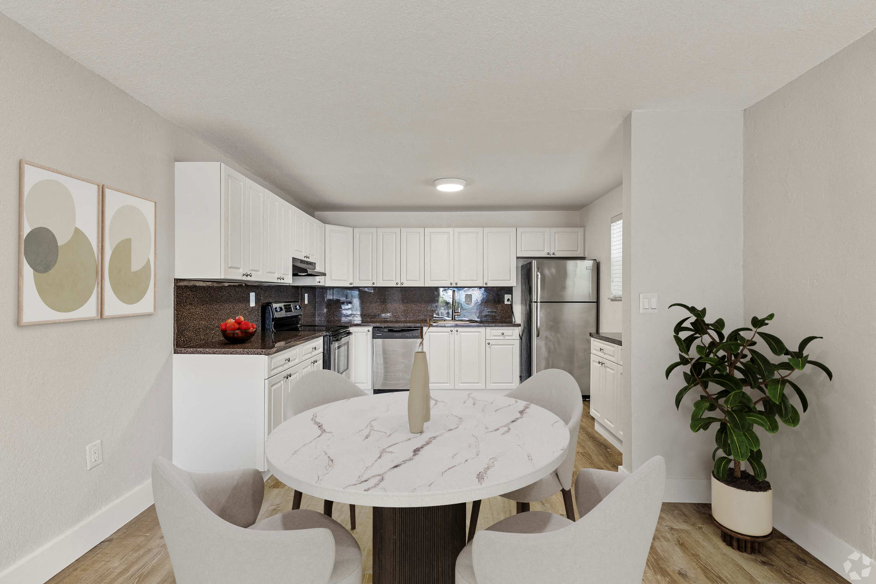 A modern kitchen with a dining table and chairs.