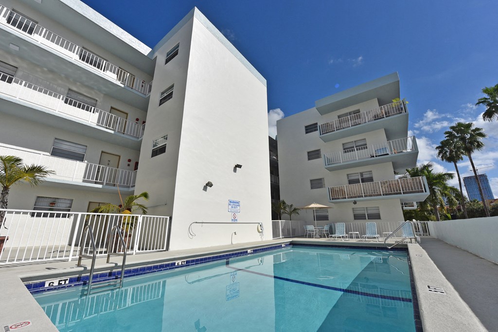 a large swimming pool in front of a building