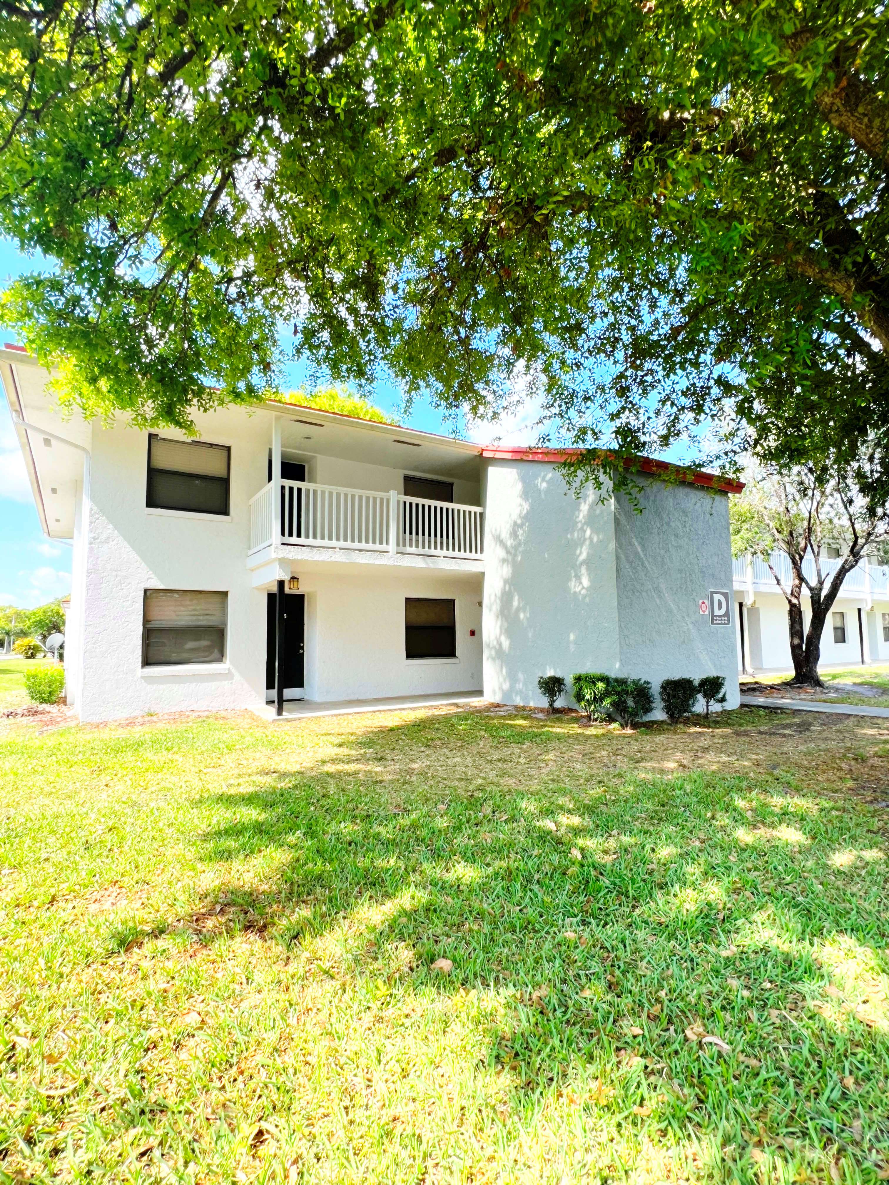 a large white house with a yard in front of it