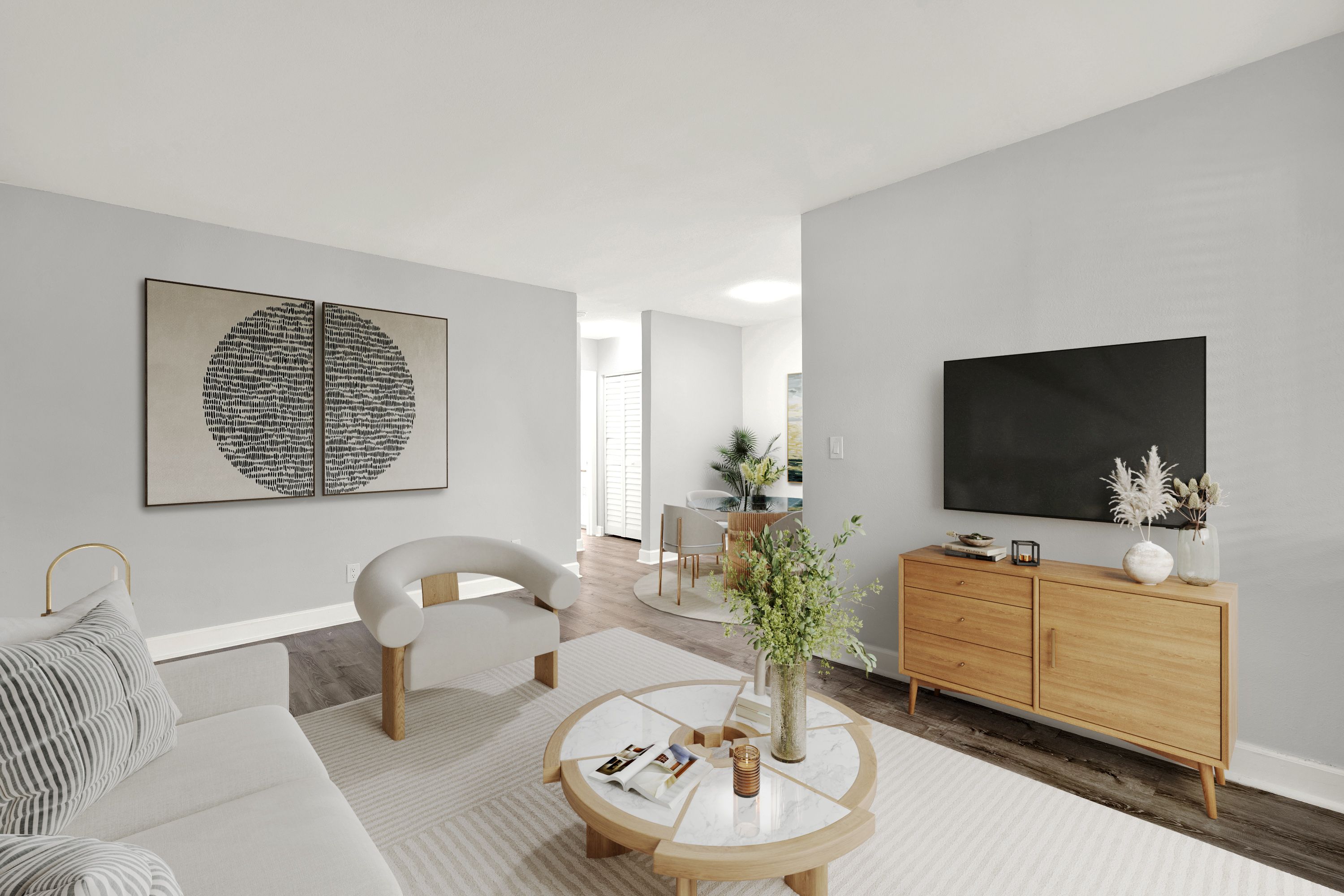 A modern living room with a white sofa, a wooden coffee table, and a large abstract painting on the wall.