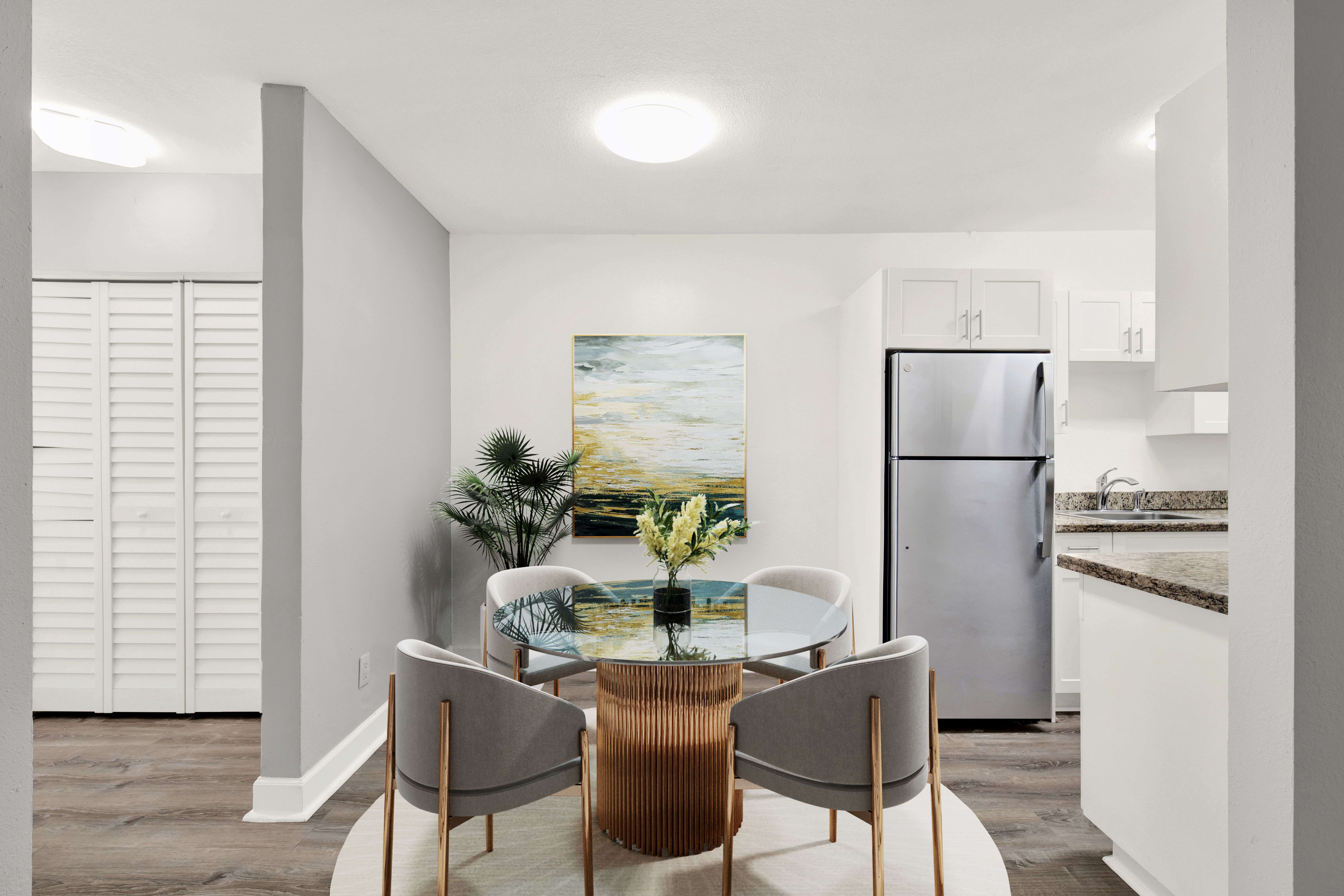 A modern kitchen with a dining table and chairs.