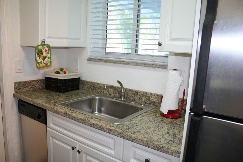 a kitchen with granite counter tops and a sink