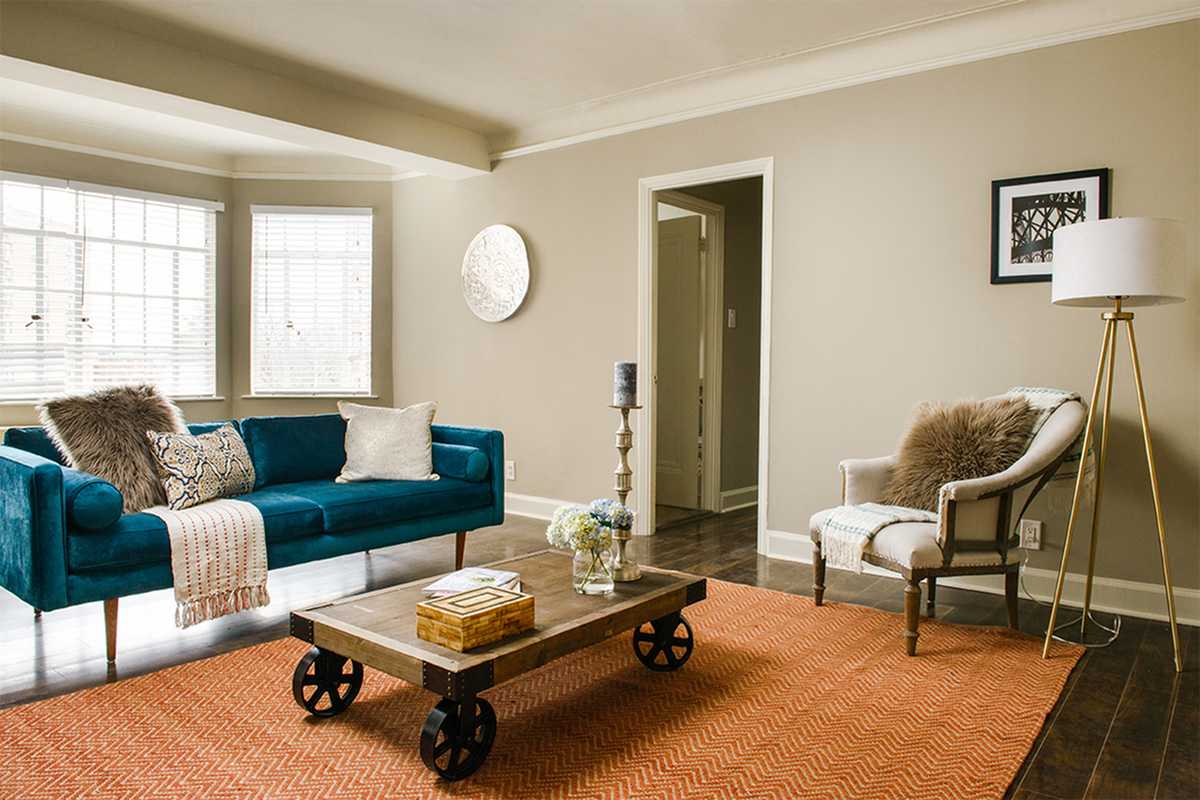 a living room with a blue couch and a coffee table