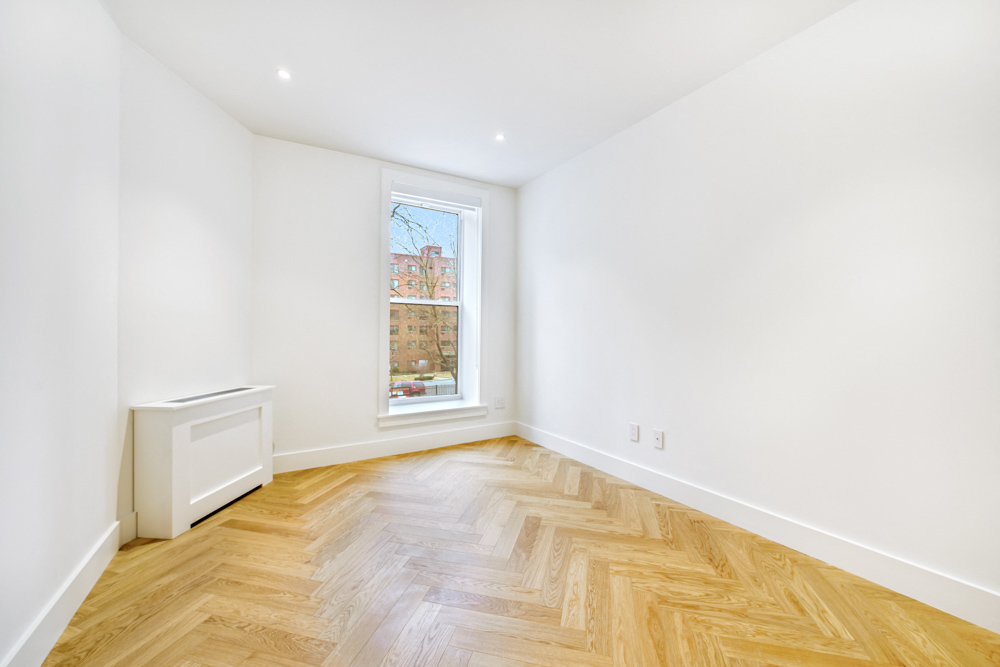 a living room with wood floors and a window